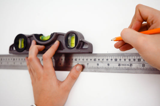 Ruler and spirit level showing measuring for wallpaper installation