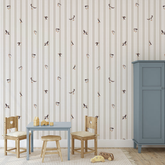 Children's room with striped wallpaper, wooden furniture, and toys.