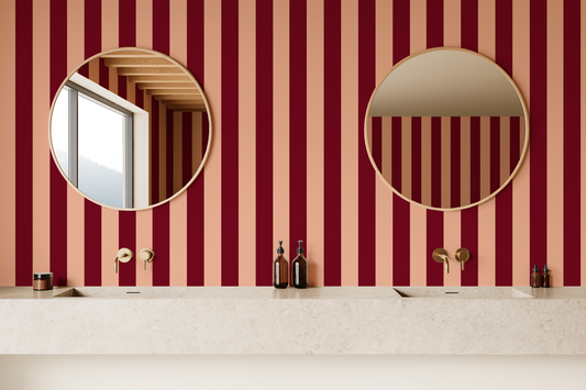Bathroom with red and beige striped wallpaper, round mirrors, and a sink.