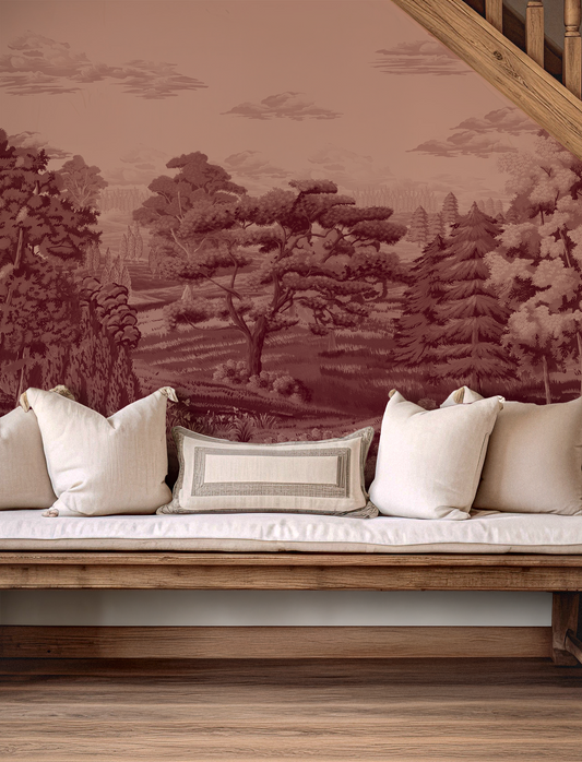 Wooden bench with white cushions against a wall with nature-themed wallpaper