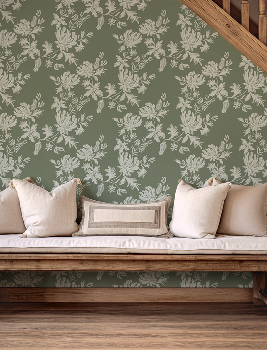 Floral wallpaper with a wooden bench and cushions in a room.