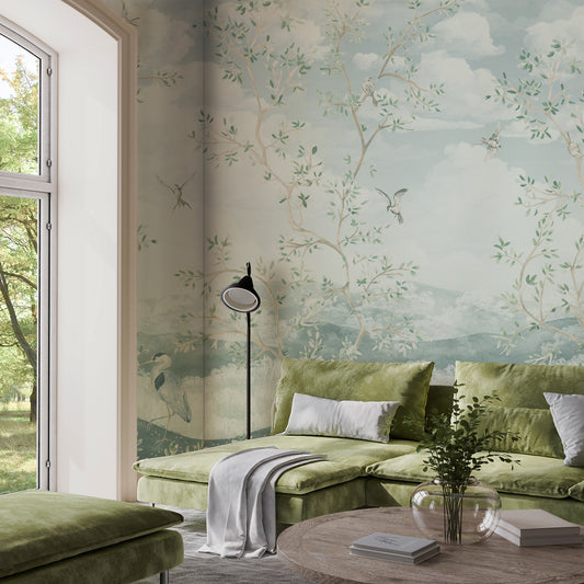 Living room with green sofa, floral wallpaper, and a lamp.