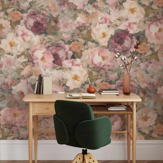 Wooden desk with a green chair against a floral wallpaper wall.