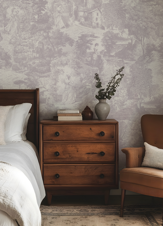 Bedroom with wooden dresser, bed, and armchair against a patterned wall.