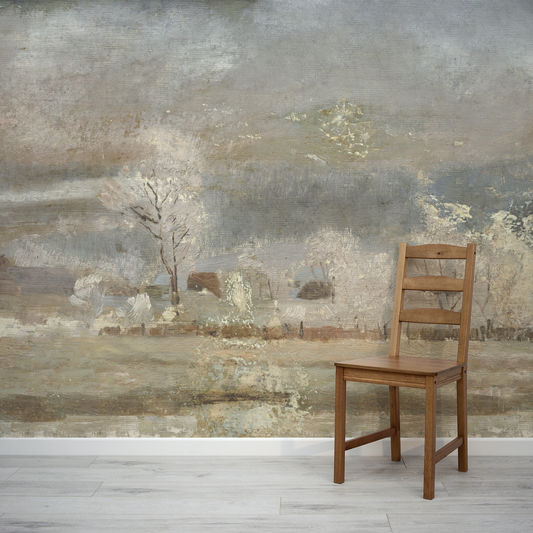 Wooden chair in front of a large landscape painting on a wall.