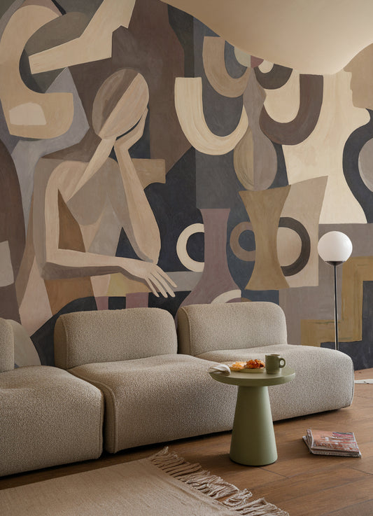 Modern living room with abstract wall art and a beige sofa.