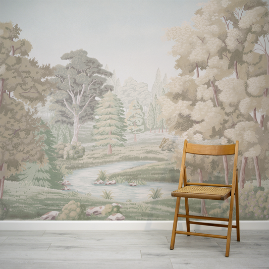 Wooden chair in front of a forest mural on a wall.
