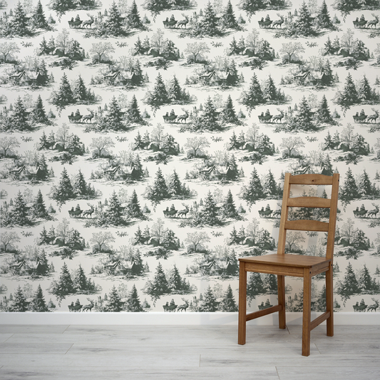 Wooden chair in front of a wall with winter landscape wallpaper featuring trees and deer.