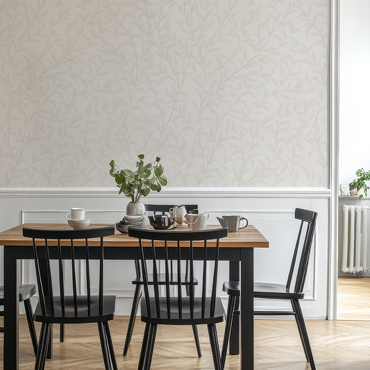 Dining area with a wooden table and black chairs against a light gray wall.