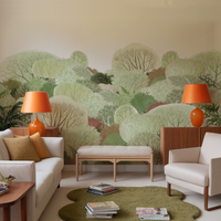 Soft watercolour forest mural in a sixties inspired living room with 2 orange lamps and a sofa and white chair.