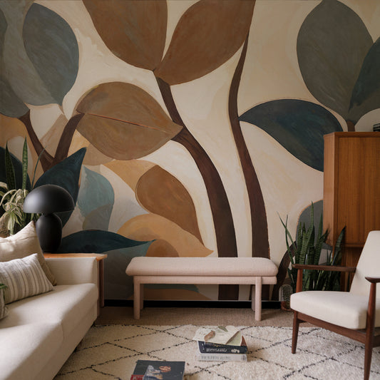 Living room with a large abstract leaf mural on the wall.