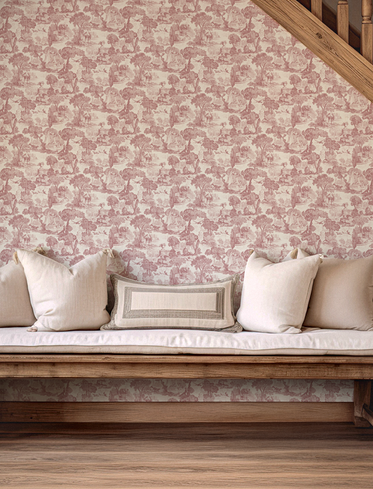 A cottage style hallway with a wooden bench and neutral cushions. Against a pink toile inspired wallpaper 