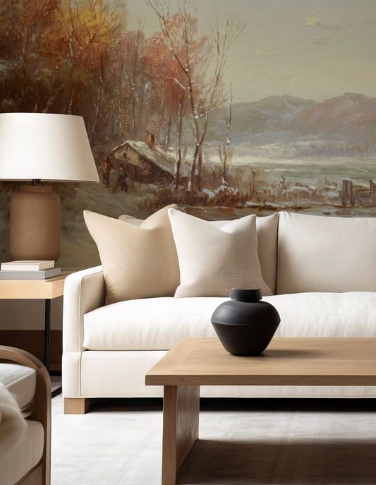 Living room with a beige sofa, wooden coffee table, and decorative items against a wall with a landscape painting.