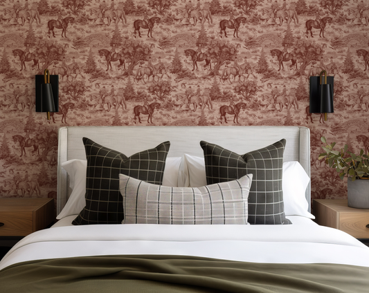 Bedroom with a bed featuring plaid pillows against a wallpapered wall with horse patterns.