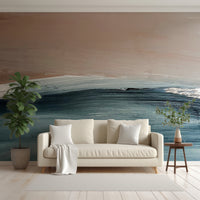 Sea Strokes Wallpaper In Living Room With White Sofa, Cushions And Blankets With Green Tall Plants Either Side Of The Sofa