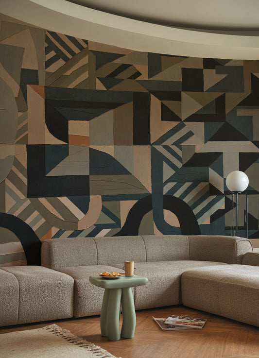 Modern living room with geometric patterned wall and sectional sofa.