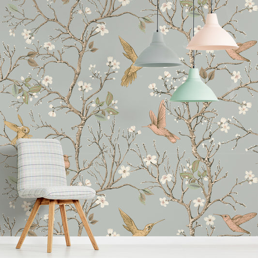 Songbird Serenade Wallpaper In Living Room With Small Grey Stool and Hanging Light Shades in Pastel Shades of Turquoise Peach and Grey