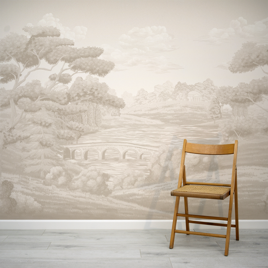 Wooden chair against a wall with a landscape mural