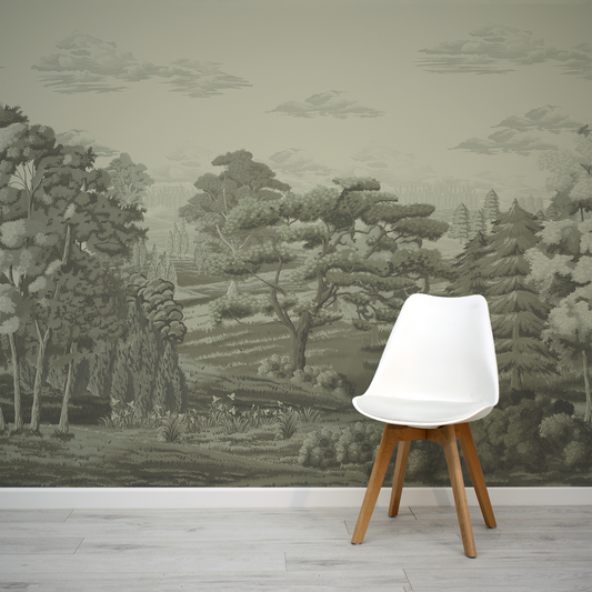 White chair with wooden legs against a wall with forest wallpaper