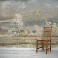 Wooden chair in front of a large landscape painting on a wall.